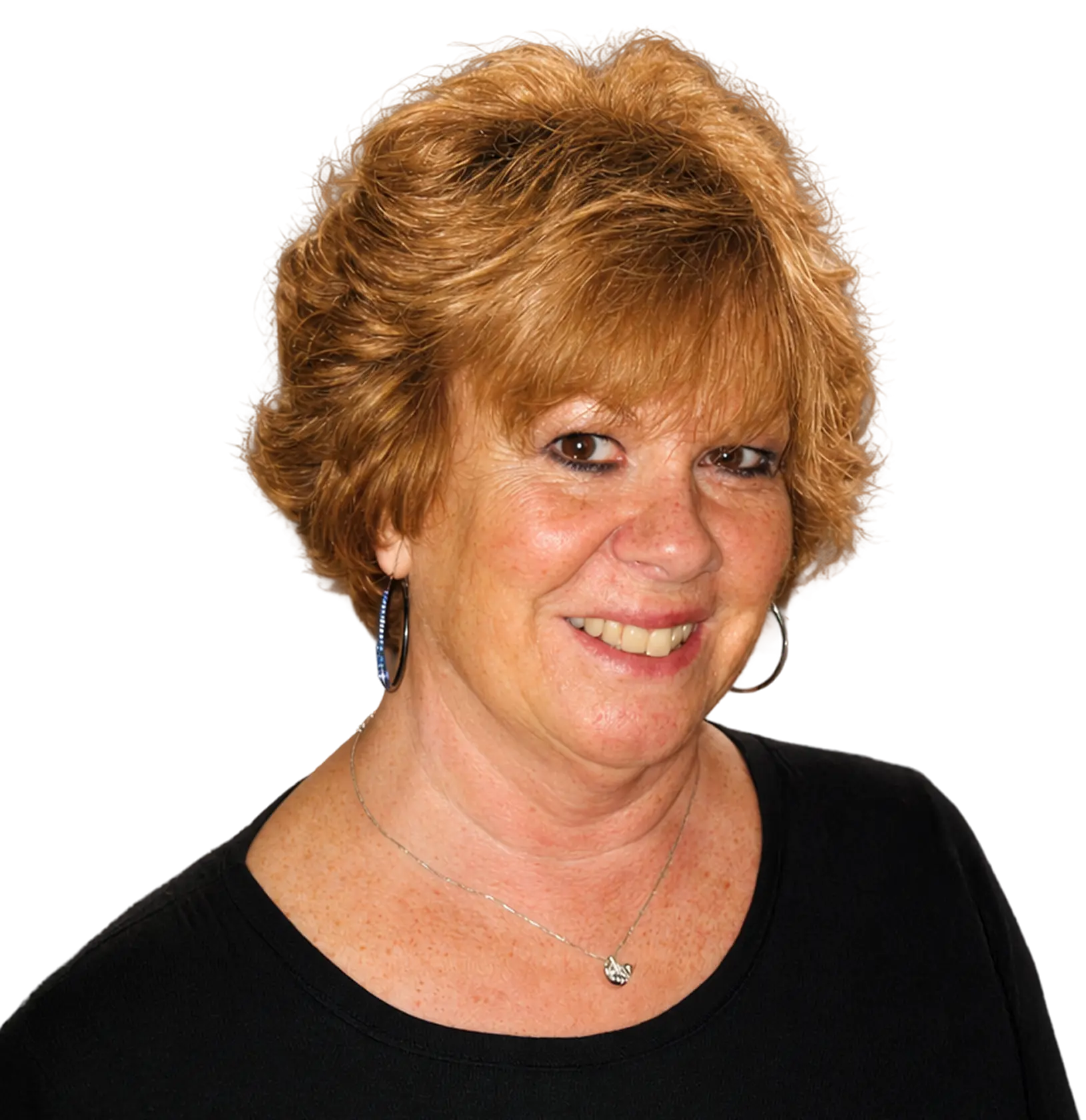 Smiling woman with short reddish-brown hair wearing a black top and a necklace, facing slightly to the right.